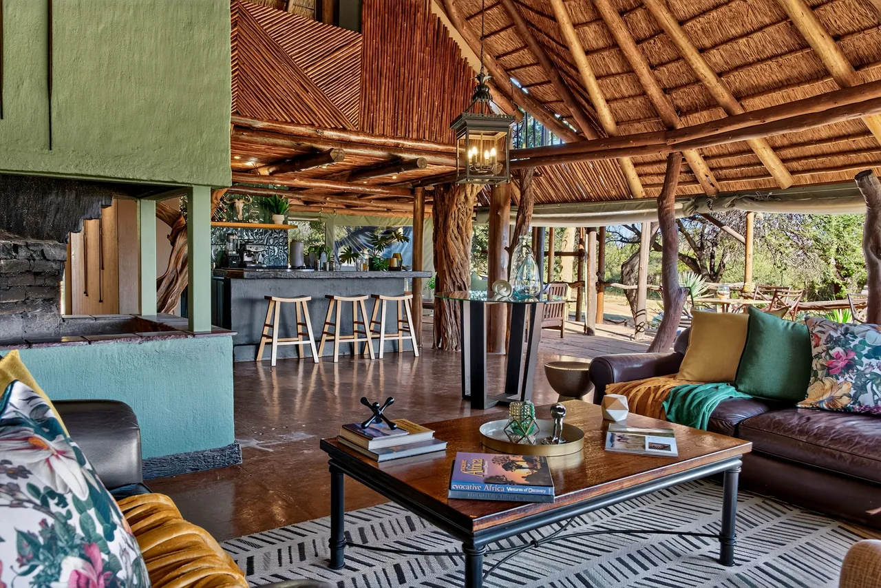 Thatched lounge and bar with patterned sofas and a lantern