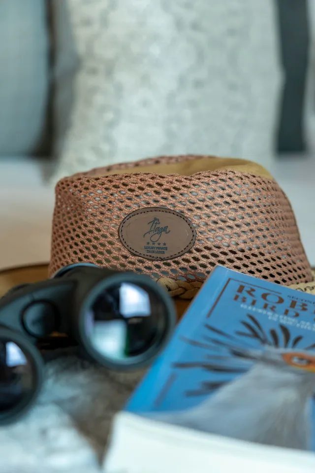 Safari hat with the Itaga patch, binoculars and a bird book
